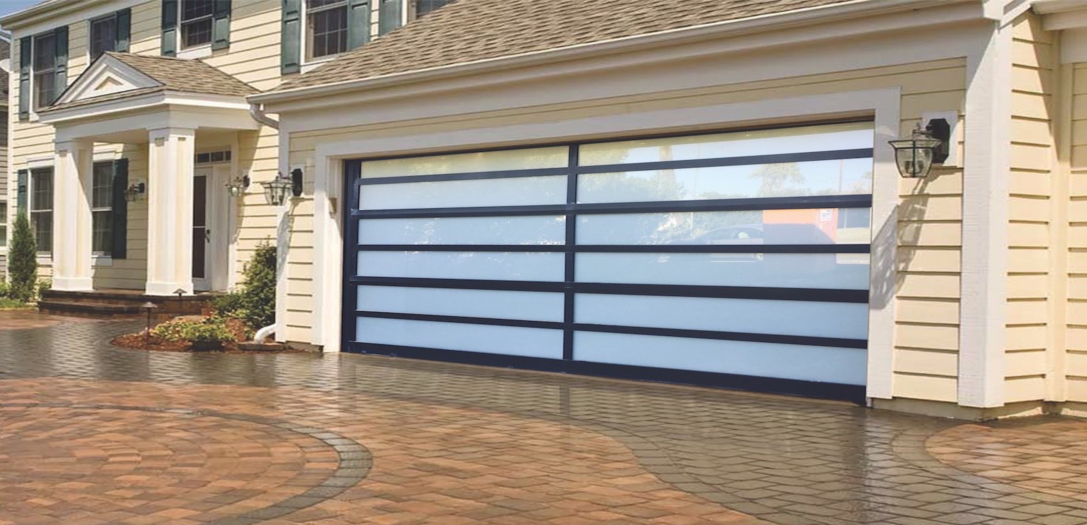 A modern aluminum garage door features sleek horizontal lines with a combination of opaque and transparent panels, set against a stylish home with light-colored siding and elegant architectural details.